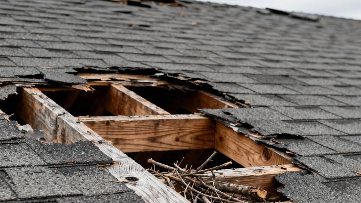 Northern Colorado residential roof showing damage requiring decision between fall repair and spring deferral